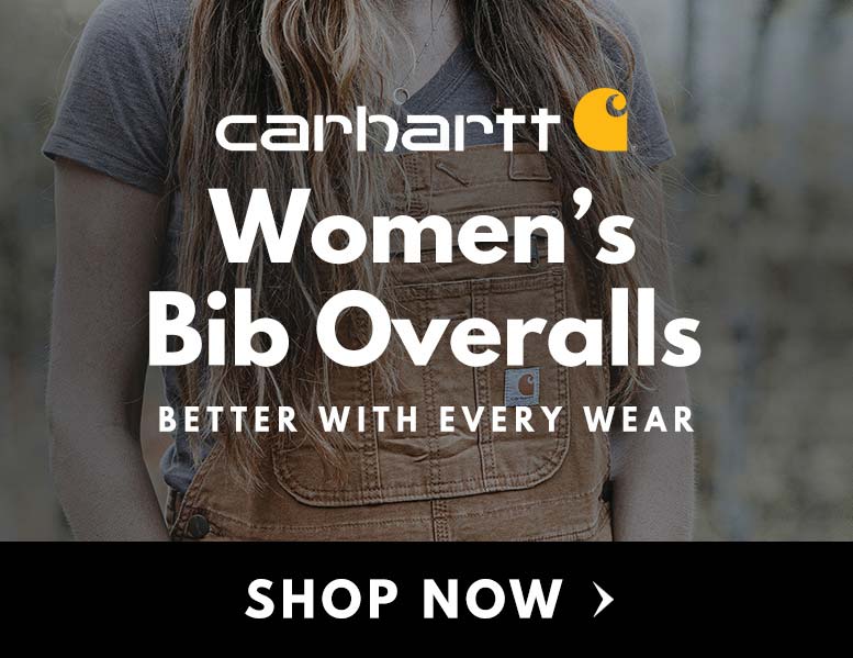 A woman with long blonde hair wearing Carhartt brown bib overalls