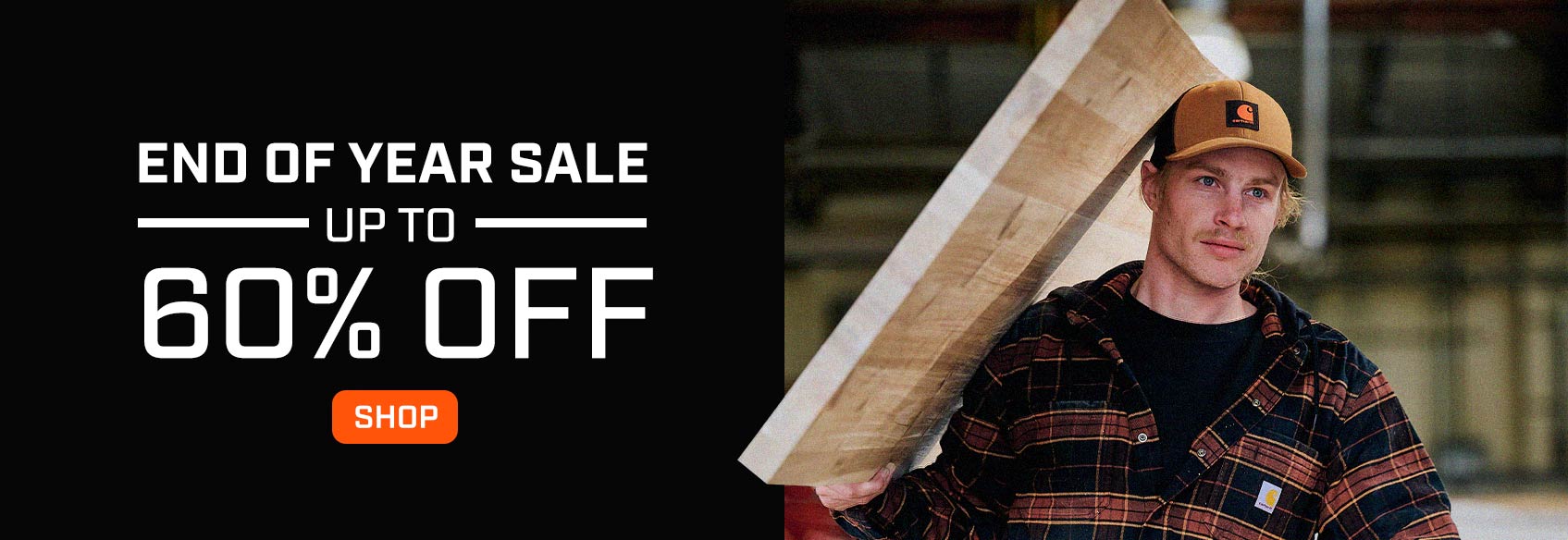 A man working in a woodshop wearing a Carhartt shirt jac