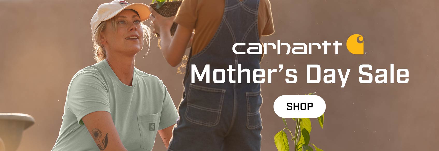 A mother wearing a Carhartt t-shirt talking to her daughter