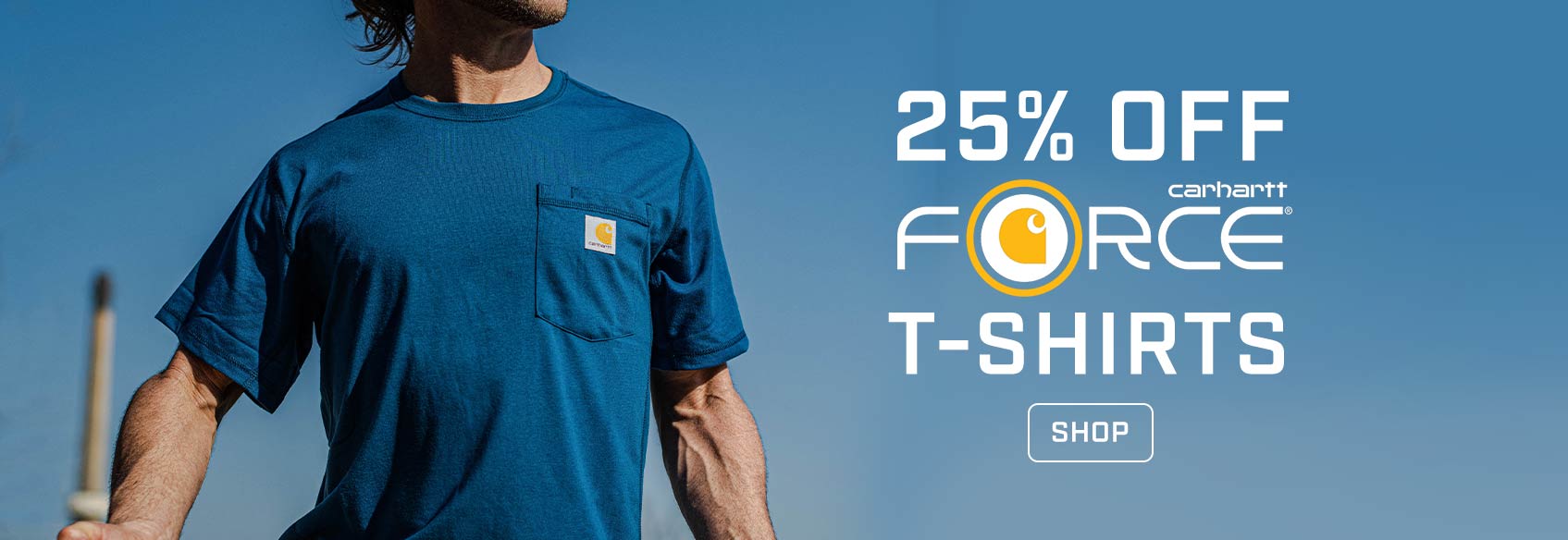 Carhartt Force t-shirt sale A man wearing a blue Carhartt t-shirt against a blue sky