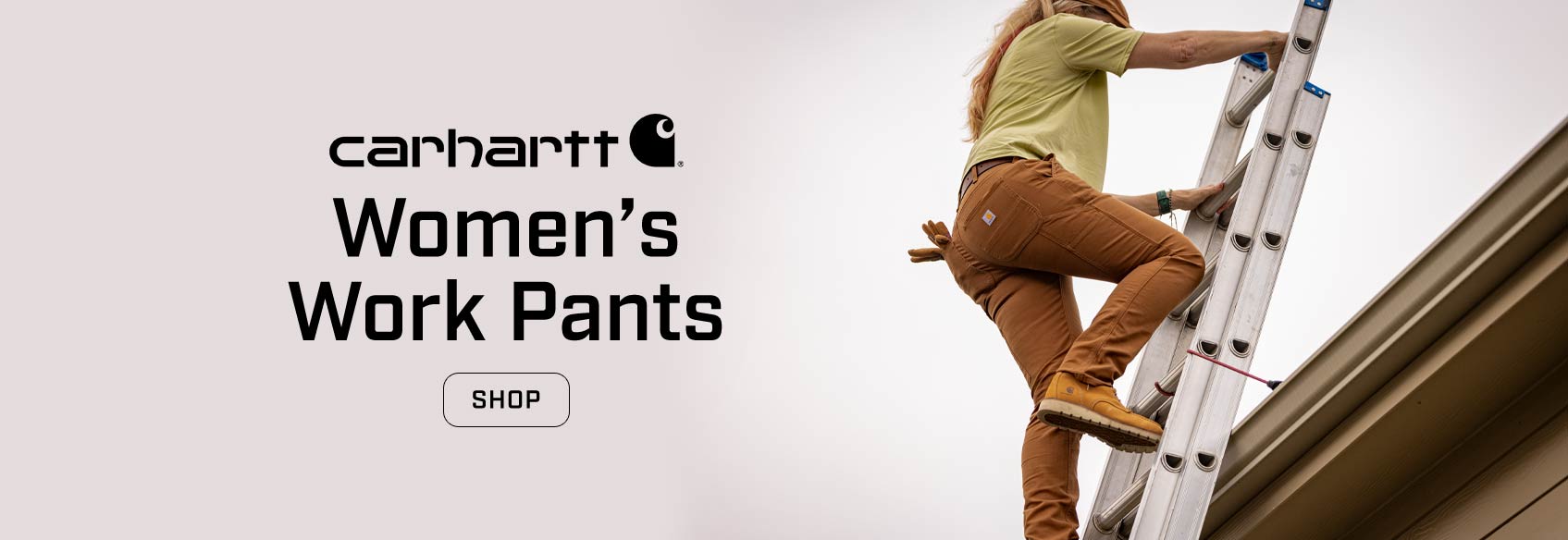 A woman in brown Carhartt pants climbing a ladder