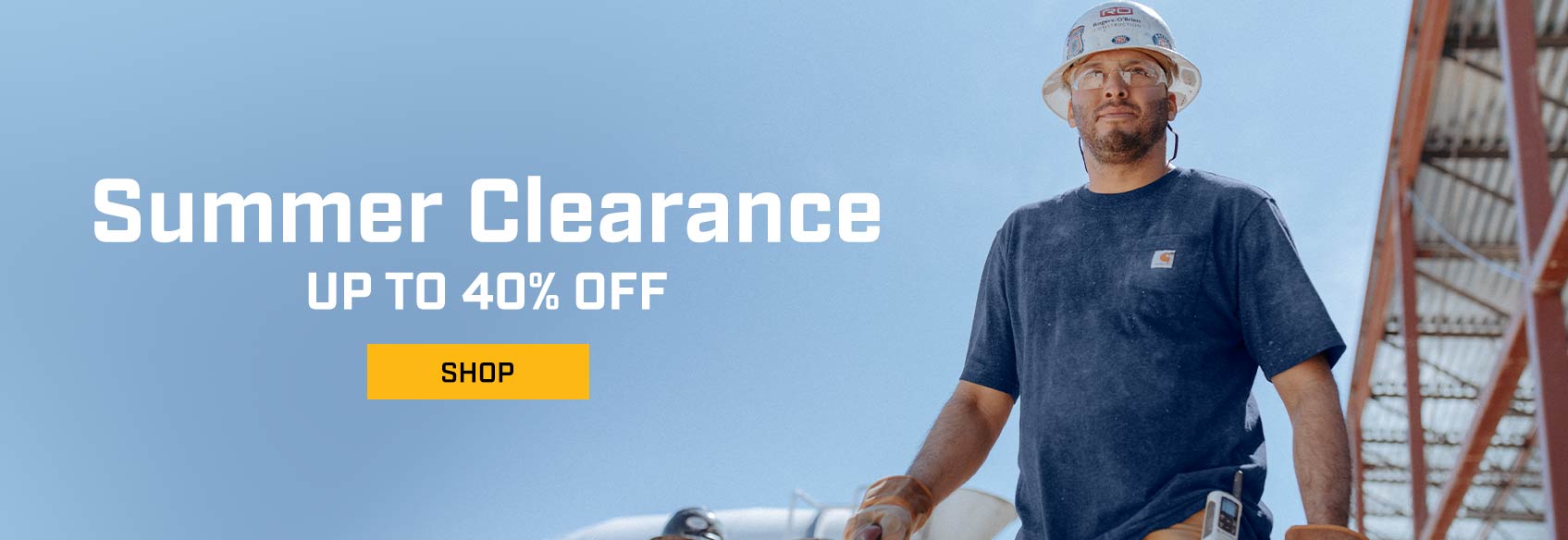 A man on a jobsite in a hard hat wearing a blue Carhartt pocket t-shirt