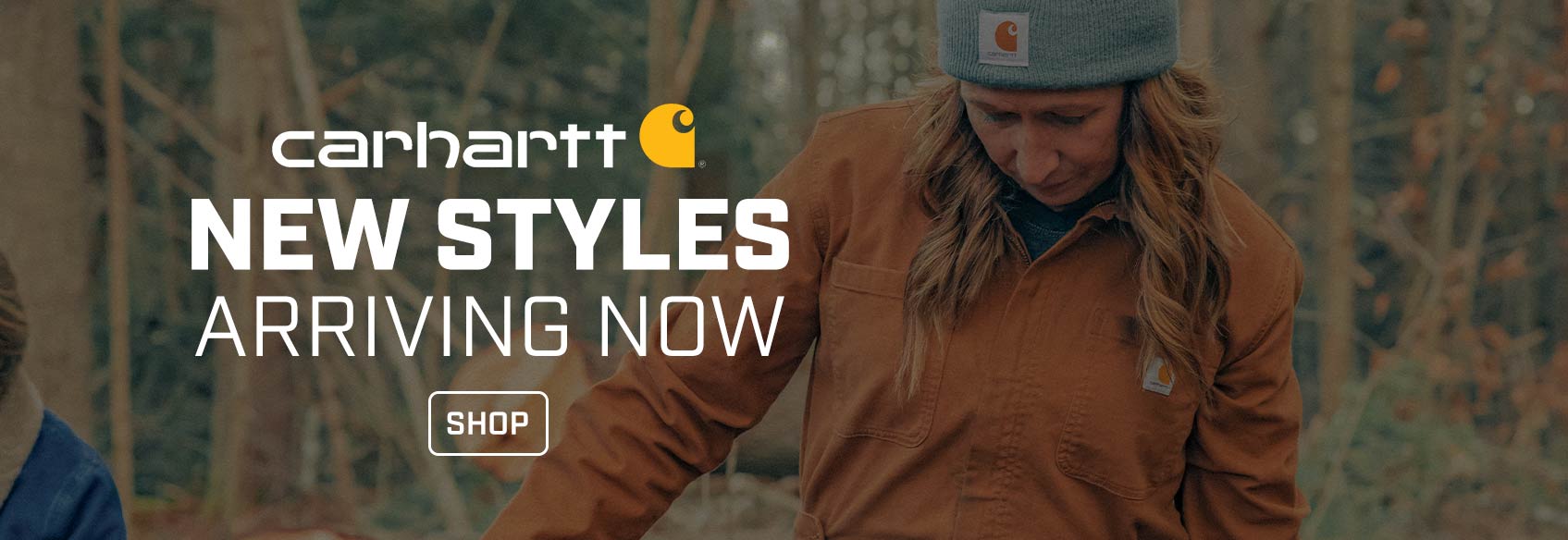 A woman in coveralls wearing Carhartt apparel. 