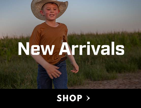 A young boy in a brown Carhartt t-shirts wearing a cowboy hat