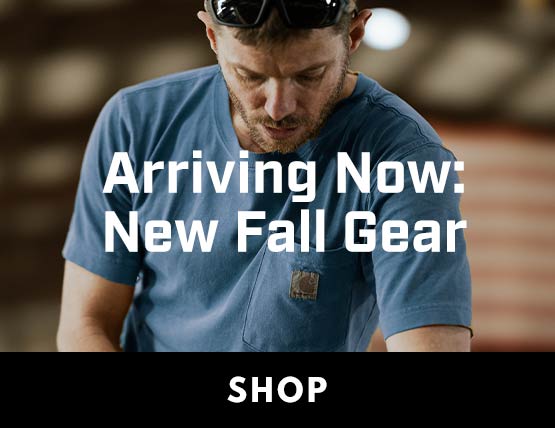 A man working in a shop with new Carhartt gear. 