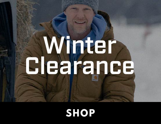 A man wearing a heavy brown Carhartt jacket in the cold. 