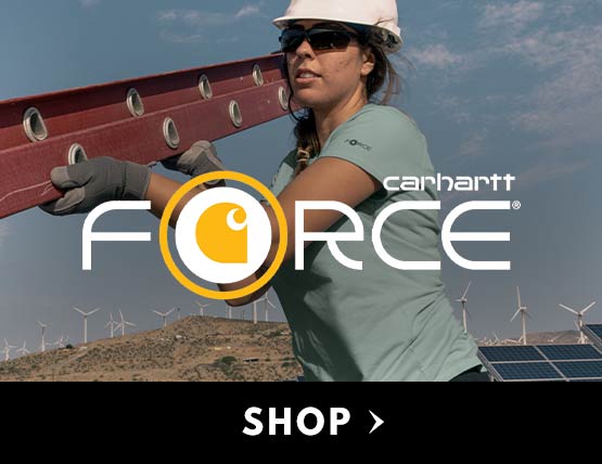 A woman wearing a Carhartt force t-shirt, hard hat and a ladder