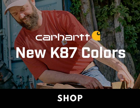 A man working outside in the sun wearing a red Carhartt K87 pocket t-shirt.