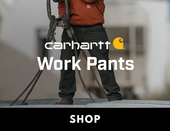 A man on a jobsite wearing Carhartt work pants and a Carhartt active jacket