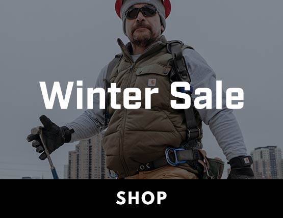 A man wearing a Carhartt vest on a jobsite with the words Winter Sale