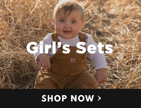 A small baby wearing carhartt overalls