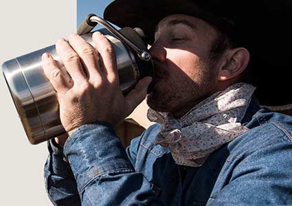 Cowboy Drinking from Thermos
