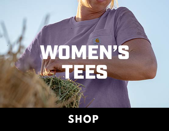 A woman bucking a bale of hay in a purple Carhartt pocket t-shirt