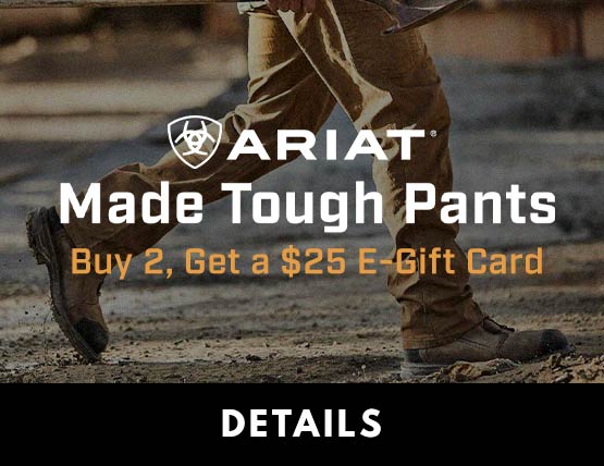 A closeup of a man wearing Ariat pants walking on a dirty job site. 