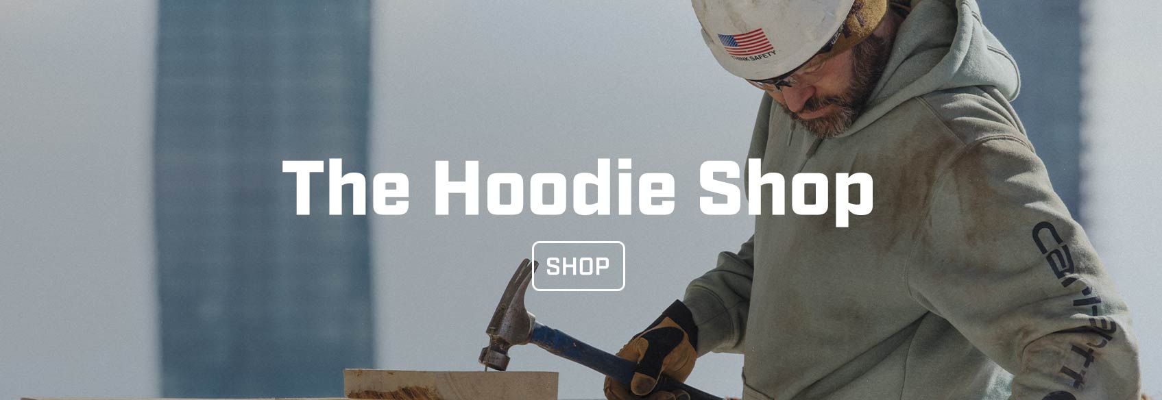 A man working on a construction site wearing a Carhartt hoodie. 