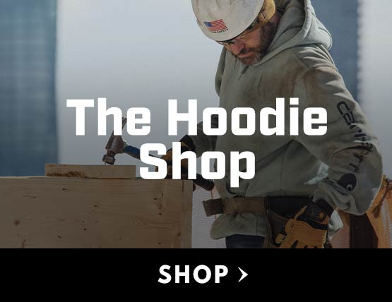 A man working on a construction site wearing a Carhartt hoodie. 