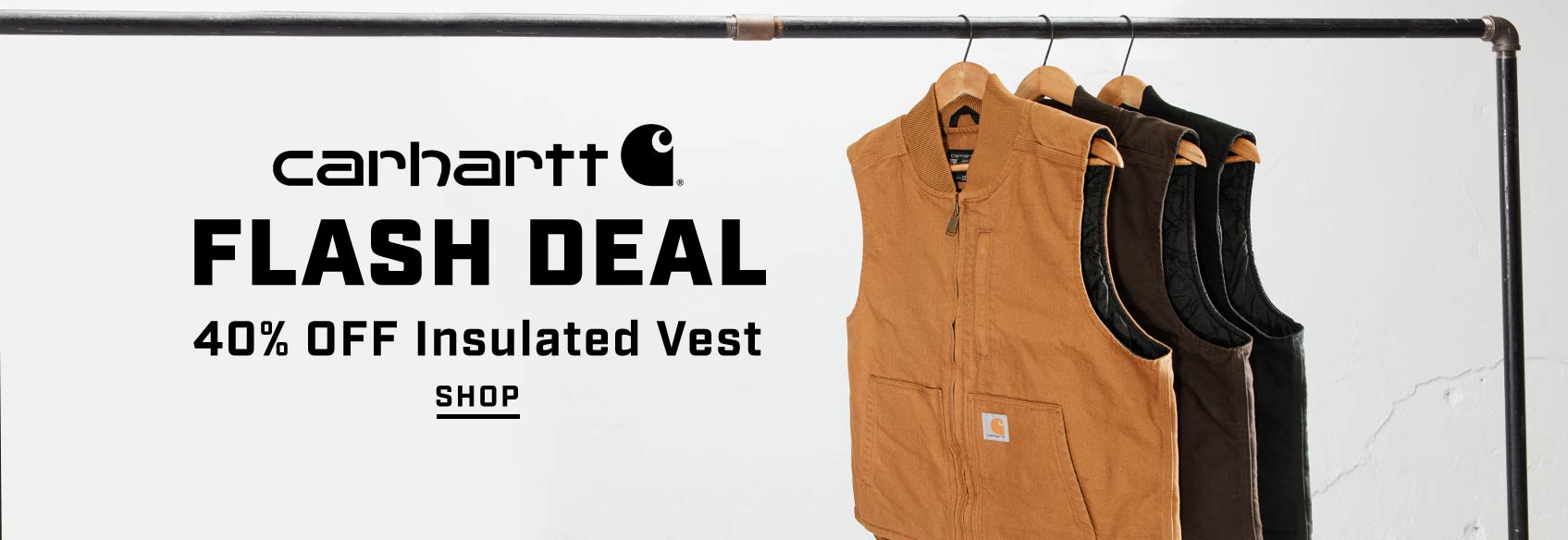 Three Carhartt bibs hanging on hangers against a white backdrop