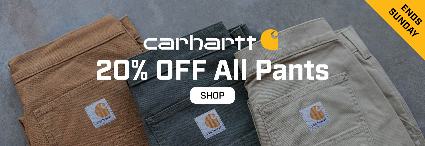 3 Carhartt pants laying on the ground - sale ends sunday