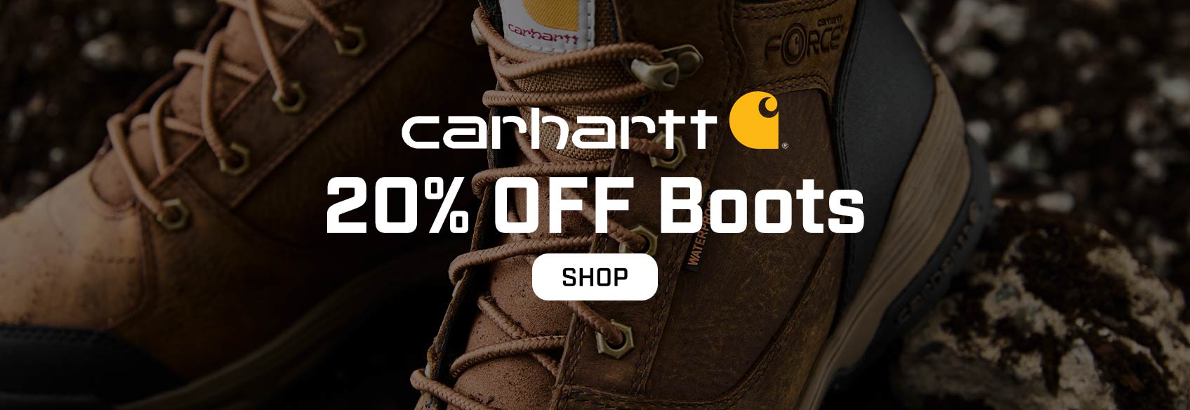 A pair of Carhartt boots on gravel