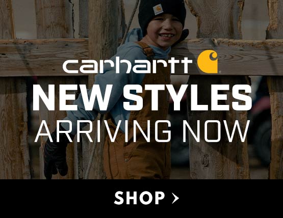 A young boy wearing Carhartt overalls. 