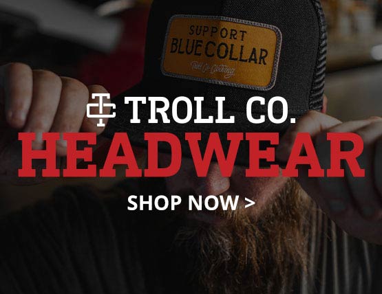 A bearded man wearing a Troll Co Trucker hat