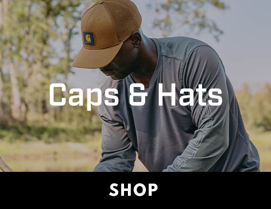 A man working outside in a blue t-shirt and a brown Carhartt hat.