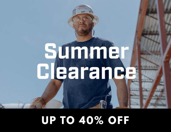 A man on a jobsite in a hard hat wearing a blue Carhartt pocket t-shirt