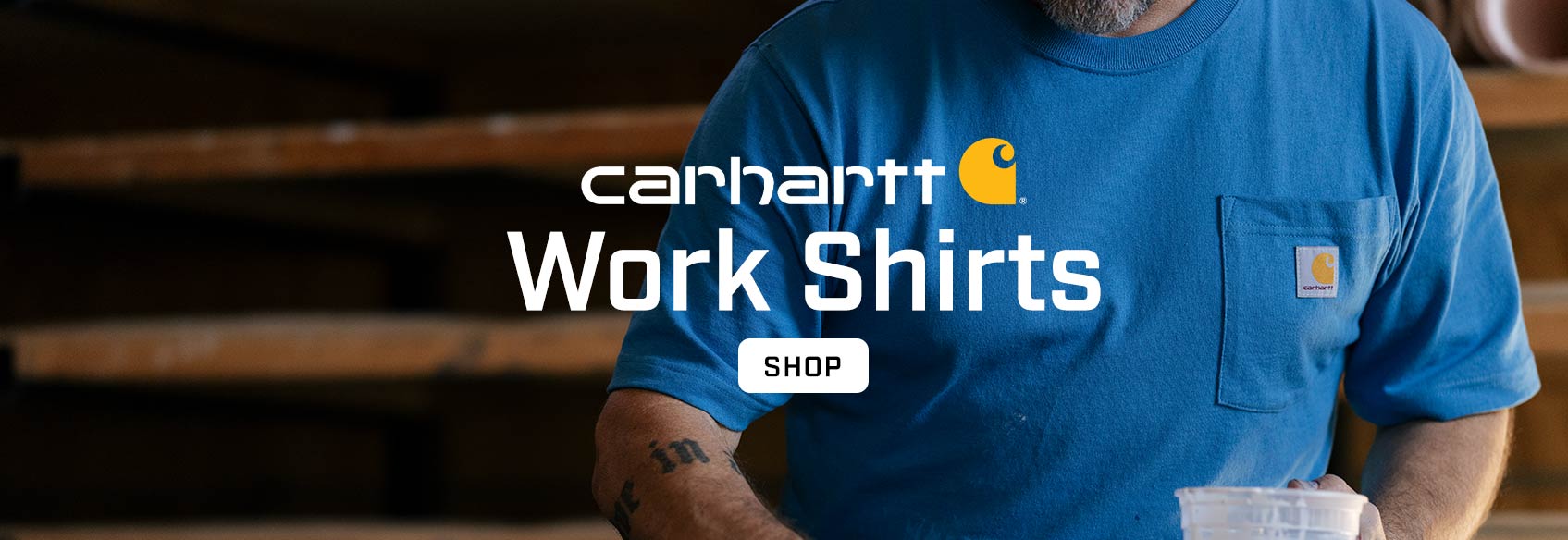 A man wearing a blue Carhartt work t-shirt