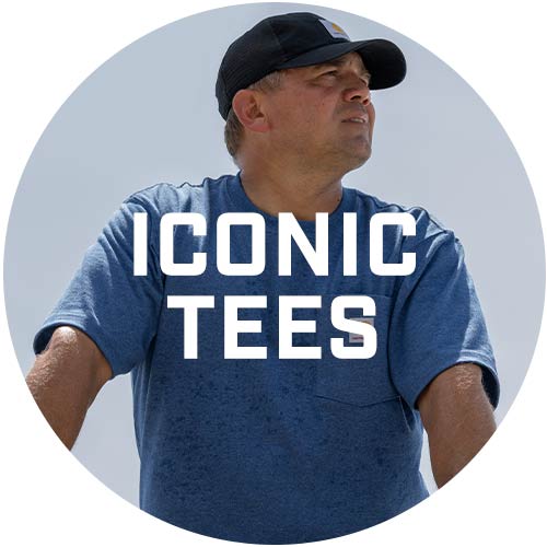 A man wearing a blue Carhartt pocket t-shirt outside